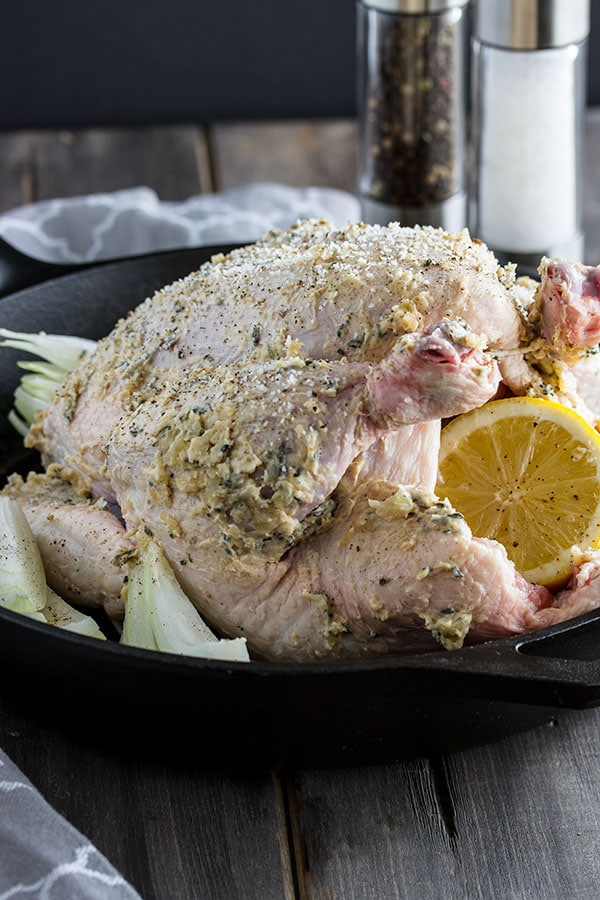 a chicken with butter and herbs rubbed over the skin to make it crispy