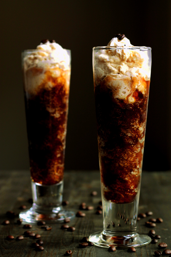 Coffee Granita in tall glasses with the cream mixture swirling with the coffee mixture