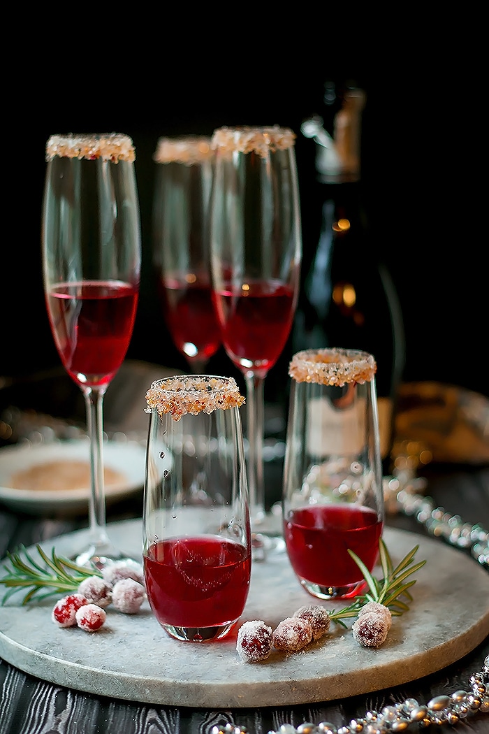 cranberry and ginger simple syrup in champagne flutes