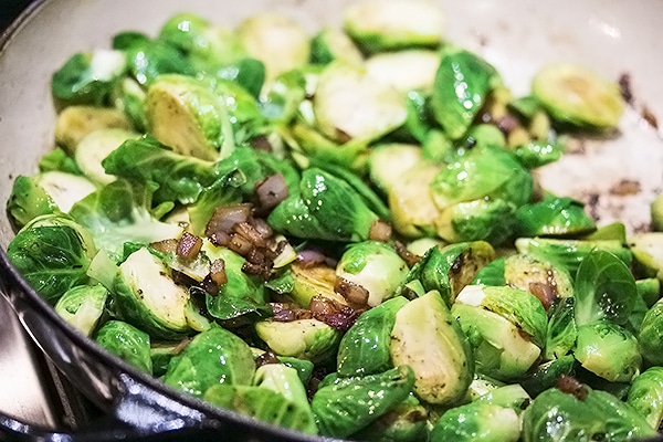 brussel sprouts with bacon and onions in a saute pan