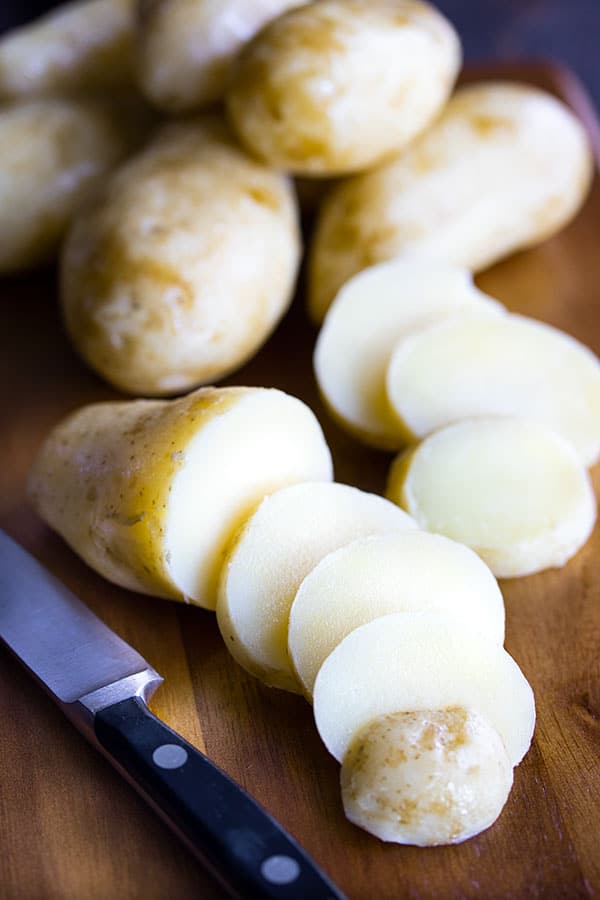 potatoes on a cutting board for the potato salad recipe