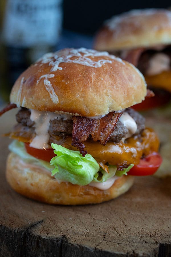 close up picture of one slider with sauce dripping down the side and crispy lettuce sticking out! 