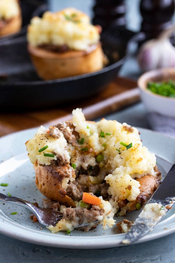 a yorkshire pudding stuffed with shepherds pie being eaten