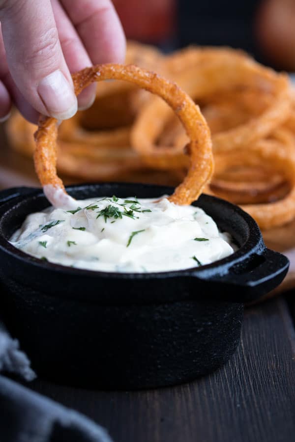 dipping an onion ring in ranch