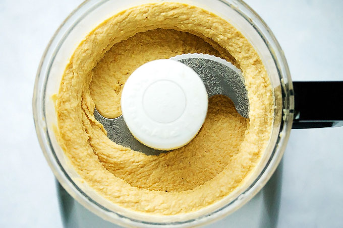 a shot of this hummus recipe being made in the food processor